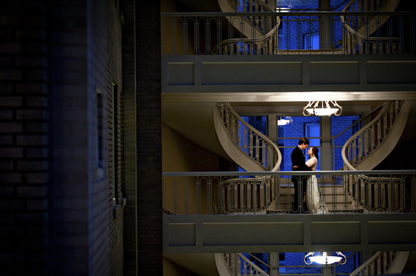 couple poses together in between spiral staircases - wedding photo by top Atlanta based wedding photographers Scobey Photography